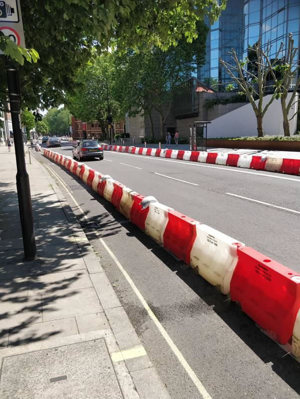 A picture containing outdoor, building, red, street Description automatically generated