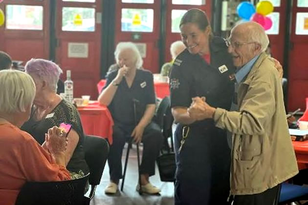 Kim Jerray-Silver dancing with one of the attendees at an event she organised at Acton Fire Station