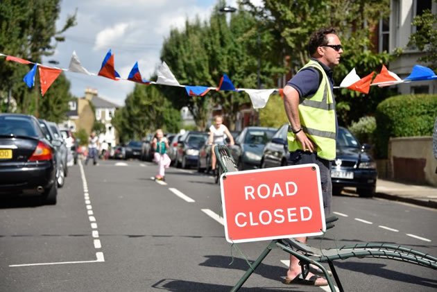 Volunteers manage access to the street