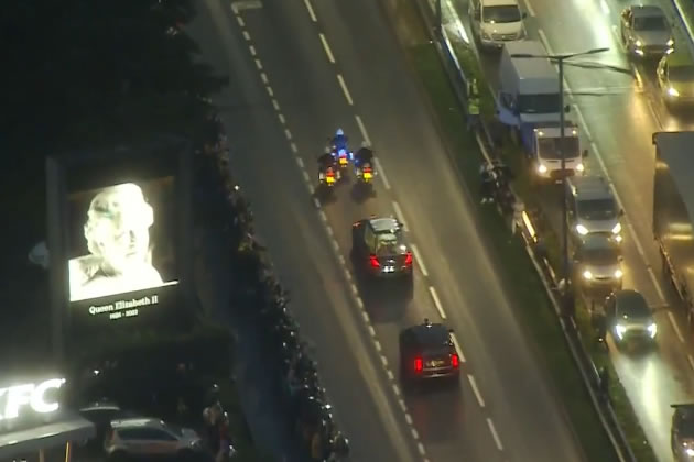 The Queen on an electronic billboard in Perivale as the cortege passes
